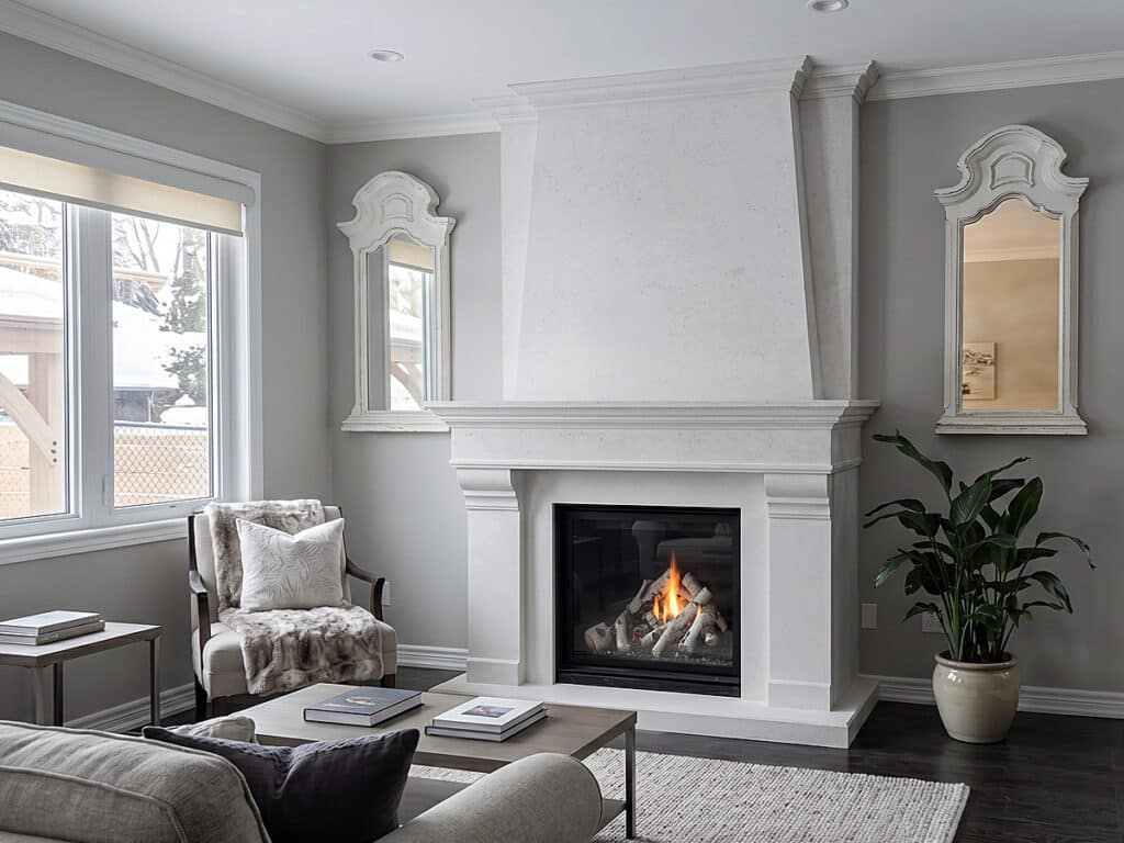 Kingsman Bentley 39 gas fireplace with birch log set and custom Omega cast stone mantel